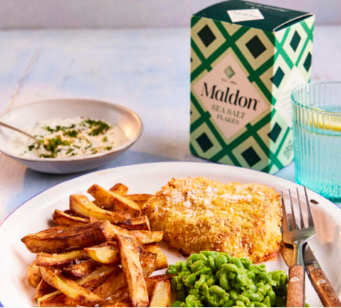 box of maldon salt flakes with food on plate infront of it