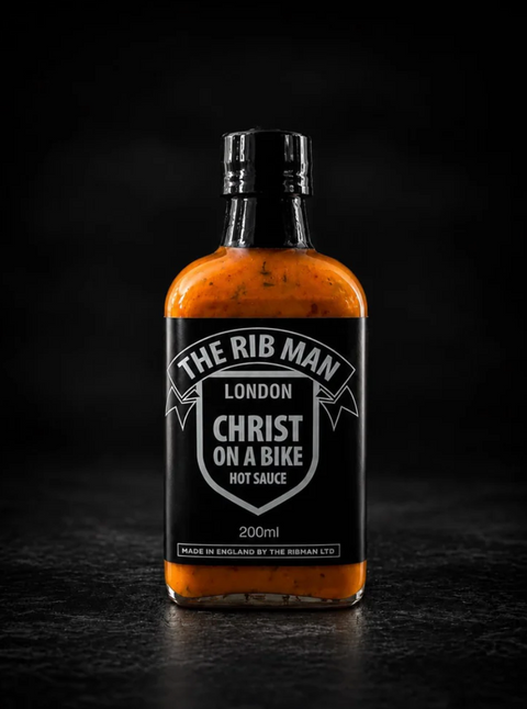 bottle of the rib man hot sauce on a black background
