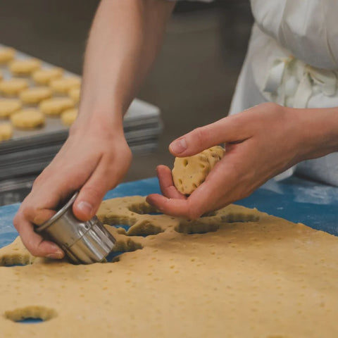 Someone cutting shortbread shapes out of dough