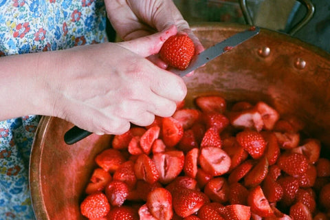 cutting up fresh strawberries for london borough jam