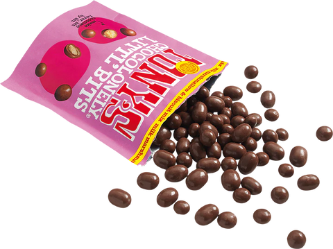 A pink bag of Fudge Jugs chocolate honey butter bits with several chocolate-covered bits spilled out on a white background.