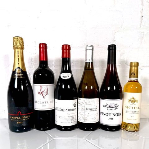 6 of the best bottles of wine from Nourished Communities range pictured side by side with a white wall behind