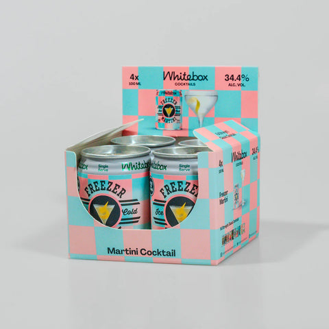 A boxed multipack of Whitabox Freezer Gold Martini Cocktail cans, shown in a pink and light blue checkerboard cardboard tray with two cans visible in front.