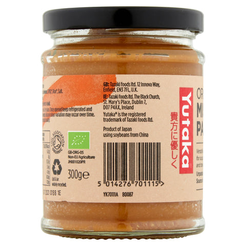 A glass jar of Yutaka miso paste with a black lid, showing the back label with text, a barcode, and a green organic certification logo on a white background.
