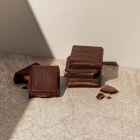 pieces of chocolate bar on a cream background