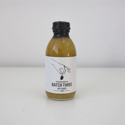 batch three hot sauce bottle from south lodon on a white background
