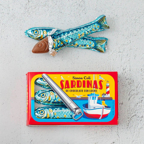 box of chocolate sardines with a partially unwrapped chocolate sardine by it