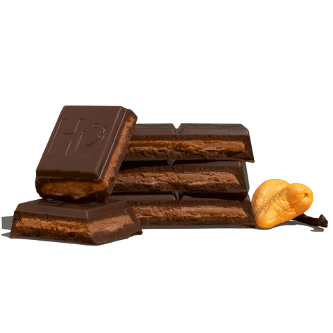 pieces of chocolate bar and cashews on white background
