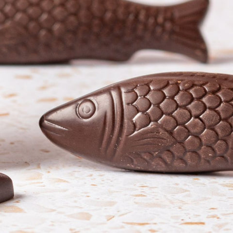 Chocolate fish shapes on a textured surface