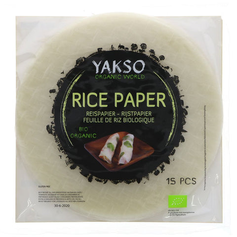 Yakso Organic World Rice Paper packaging showing 15 pieces of organic rice paper. The product is sealed in a clear plastic bag with a prominent black circular label featuring green and white text and a small photo of spring rolls.
