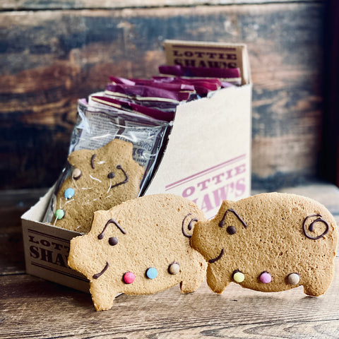 gingerbread pigs on wooden surface