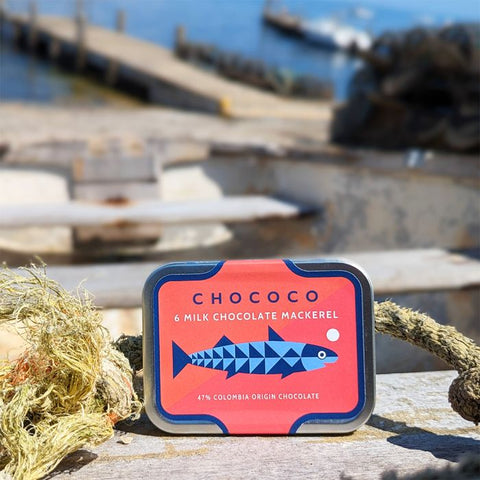 Chococo milk chocolate mackerel packaging on a wooden surface with a blurred background