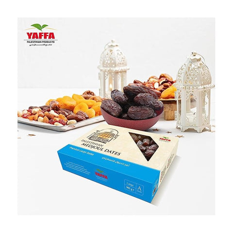 box of dates in front of bowl of dates and plate of various nuts