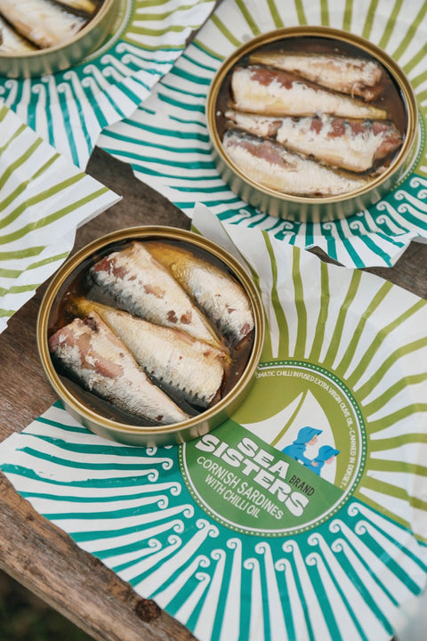 Open round tins of cornish sardines